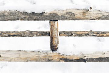 Fototapeta premium A wooden fence partially covered in snow against a white background.