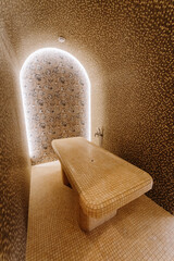 Obraz premium Luxurious spa steam room with tiled massage table and ambient lighting for ultimate relaxation