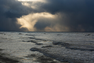 Wonderfully beautiful sunset by the sea in winter with ice