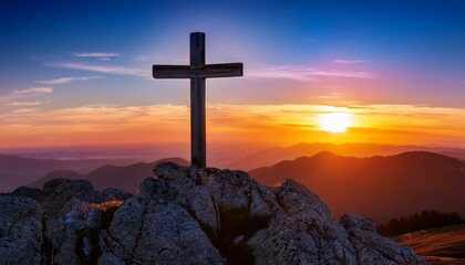 a wooden cross stands atop a rocky peak against a vibrant sunset in the mountains illuminated by warm orange and purple hues during twilight