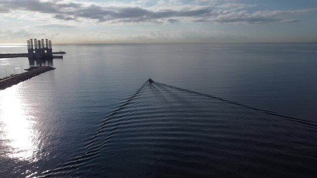 Aerial approach to a small fishing boat at the Alicante port entrance, Spain
