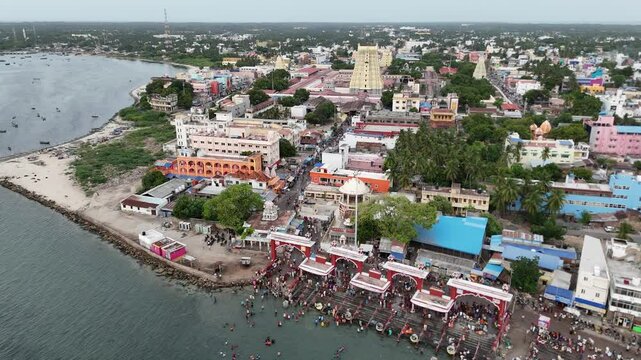 Aerial video of devotees offering prayers and performing rituals sacred Agni Theertham, a holy dip in the sea, where pilgrims take a dip to absolve their sins. Ramanathaswamy Temple in Rameshwaram