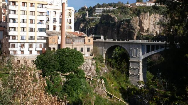Titl down over El Kantara bridge, abandoned factory and Rhumel gorge in Constantine, Algeria