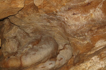 Unique rock formations and textures found in an underground cave during the daylight hours