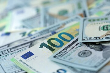 Big pile of Euro and USD banknotes. Many european and united states dollars