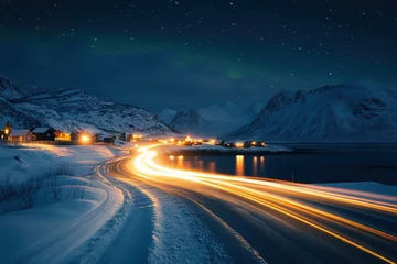 Light trails illuminating snowy road at night in lofoten islands, norway