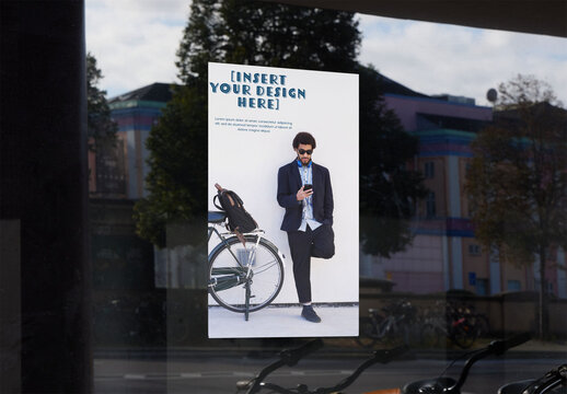 Blank Sign on Shop Window in Copenhagen Reflecting the Local Environment on a Sunny Day. Customizble PSD template