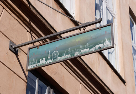 Customizable mockup of Red Metal hanging Sign Mounted on a Building Facade in Copenhagen Showcasing Local Architectural Style.