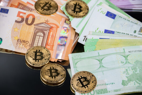 Golden Bitcoin coins, arranged alongside a pile of Euro notes, symbolizing the interplay between traditional and digital currency in modern finance