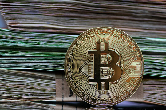Golden Bitcoin coins, arranged alongside a pile of Euro notes, symbolizing the interplay between traditional and digital currency in modern finance