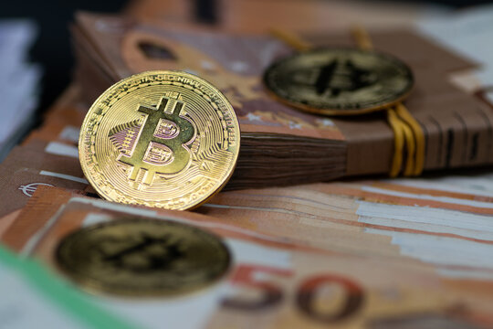 Golden Bitcoin coins, arranged alongside a pile of Euro notes, symbolizing the interplay between traditional and digital currency in modern finance
