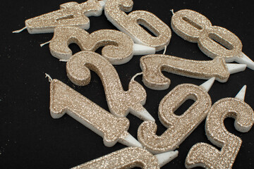 Birthday numeral candles on black background	