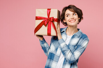 Young woman she wear blue shirt white t-shirt casual clothes hold in hand present box with gift...