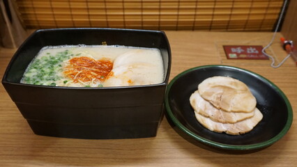 Japanese Ramen in Bento-Style Bowl with Chashu Pork on Side Plate