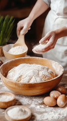 Fototapeta premium Hands of a baker dusting flour onto dough while surrounded by eggs and bowls in a rustic kitchen