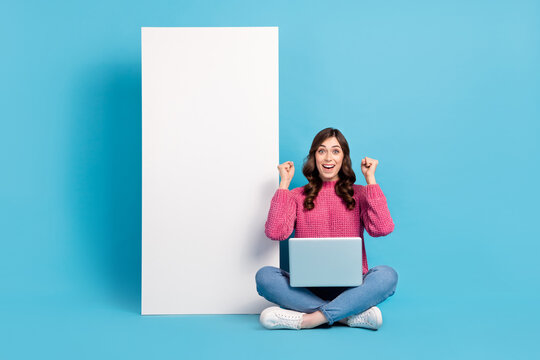 Full body cadre of young girl surprised victory gambling company lottery lady online app parimatch sit use laptop isolated on blue color background