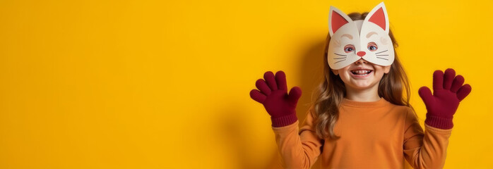banner copy space portrait quadrober child girl in animal cat mask on solid yellow studio background, quadrobics furry terrians and carnival festive action.