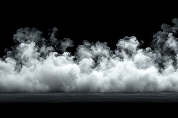 Fototapeta premium Thick white smoke drifts over a dark background, creating a mysterious surreal atmosphere