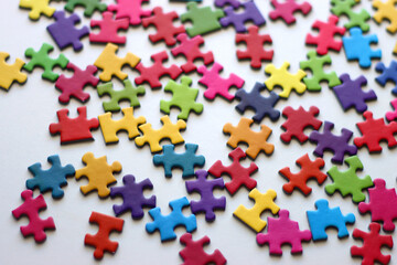 Colorful jigsaw puzzle pieces on white background. Selective focus.