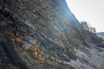 Close-up of layered sedimentary rock formations with diverse textures and natural color tones....