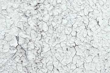 Peeling paint on the wall. Old concrete wall with cracked flaking paint, closeup of cracks and...