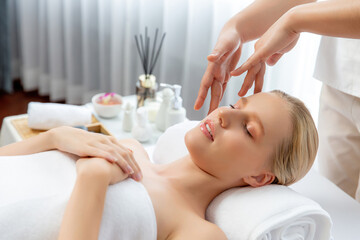 Caucasian woman enjoying relaxing anti-stress head massage and pampering facial beauty skin...