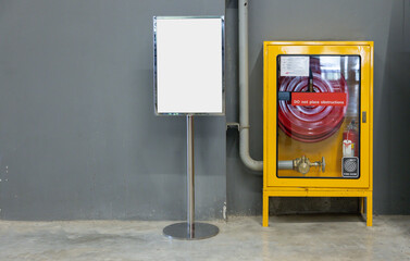 A fire hydrant is next to a white sign.