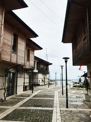 Charming coastal village street with wooden houses by the sea in Nesebar, Bulgaria.
