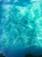 Serene turquoise ocean surface with sunlight reflections