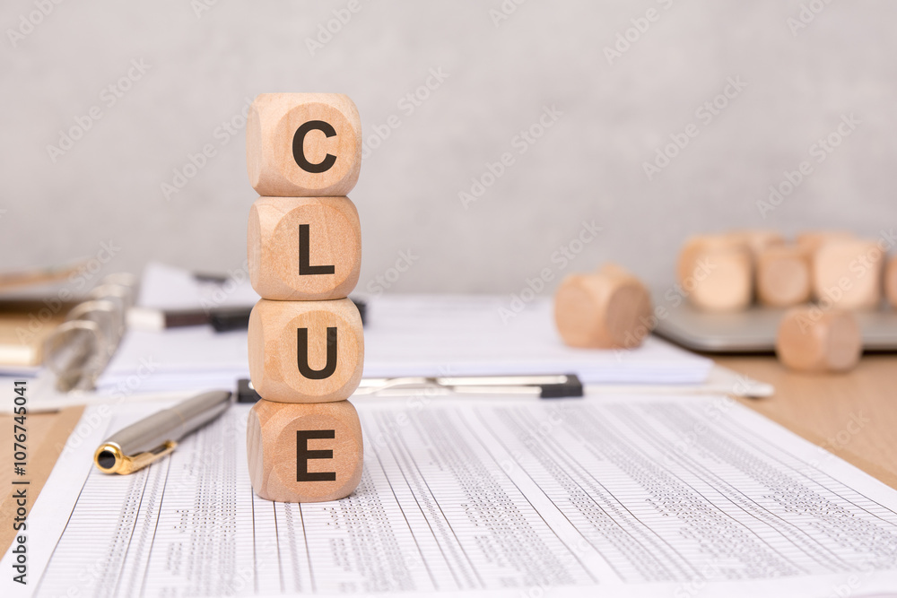 Poster clue blocks arranged on a table along with papers and a pen for productive brainstorming