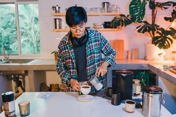 Asian Man using Italian classic Moka coffee pot pouring, coffee maker with equipment tool brewing table at the kitchen home