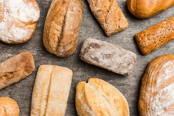 Homemade natural breads. Different kinds of fresh bread as background, top view with copy space