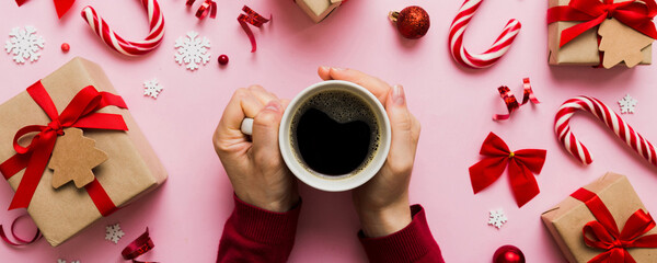 Woman holding cup of coffee. Woman hands holding a mug with hot coffee. Winter and Christmas time concept