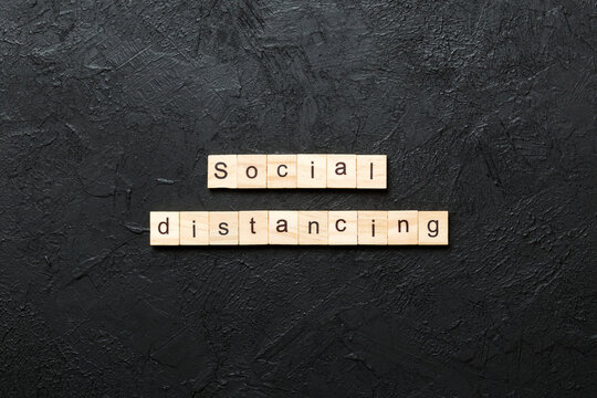 social distancing word written on wood block. social distancing text on cement table for your desing, concept - Powered by Adobe