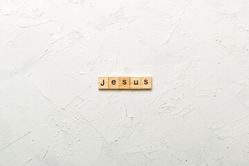 Jesus word written on wood block. Jesus text on table, concept