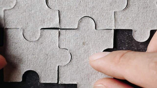 Close up hand holding pieces of jigsaw puzzle, Business solutions, success and strategy concept.