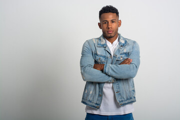 medium shot with copy space of a black serious man with arms crossed looking at the camera disappointed isolated on a white background 