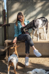 Woman Feeding Goats at Animal Farm