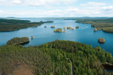 Fototapeta premium Drone view of a large blue lake in Sweden which contains some small recreational boats