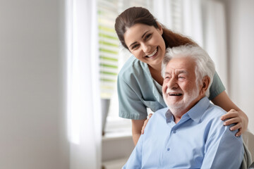 Fototapeta premium Caring female doctor embracing helping happy senior male disabled patient adult affectionate togetherness.