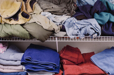 Messy laundry room with clothes and towels