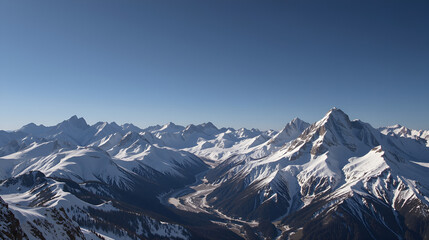 Fototapeta premium Snow-covered mountains landscape with clear blue sky during daytime