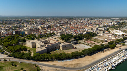 Obraz premium Aerial view of the castle located in Barletta, Puglia, Italy. It was a medieval fortress and today it is a museum. In background is the Basilica of Santa Maria Maggiore, cathedral of the town.