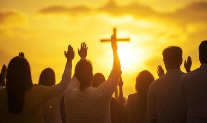 Fototapeta premium A group of people stand praying at sunset, hands raised in worship, cross in the background