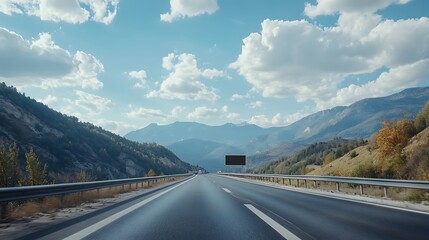 Billboard mockup on a highway with mountains in the distance, blank area for advertising