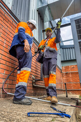 african workers fixing air conditioning, hvac outdoors unit industrial