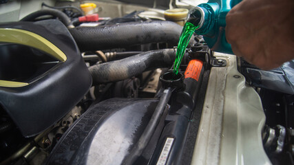 Radiator coolant poured in by a pickup truck mechanic. Change fluid in car machinery