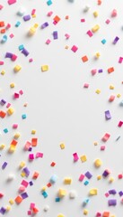 Fototapeta premium Colorful confetti scattered on white background for celebrations