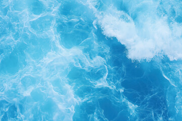 Obraz premium Dynamic close-up of turbulent ocean waves in vivid blue hues, capturing the motion and energy of water with foam and splashes.