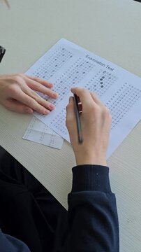 A school student cheats on a test using an answer sheet concept 
